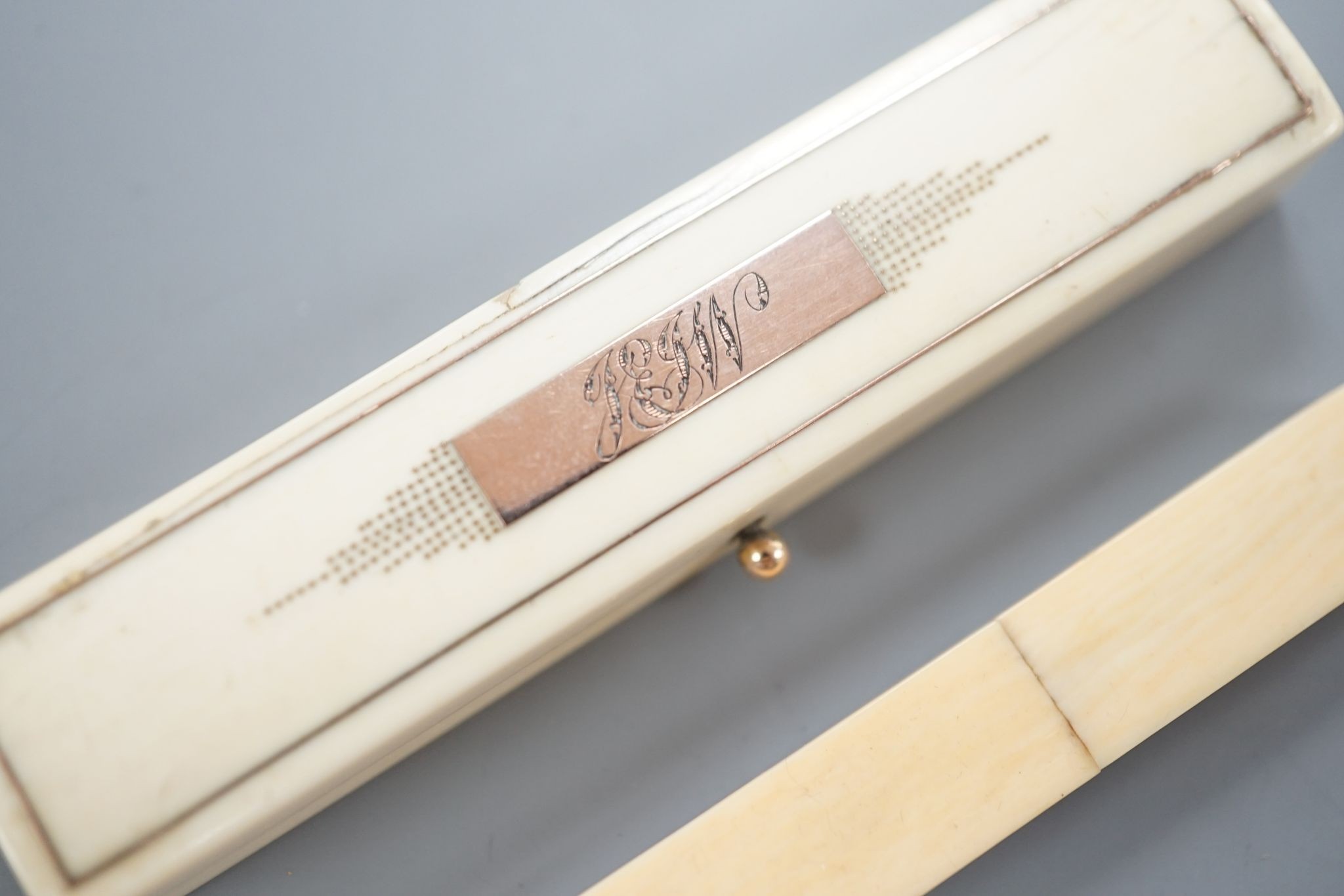 A yellow metal inset ivory tooth pick case and an Ivory needlecase 8cm